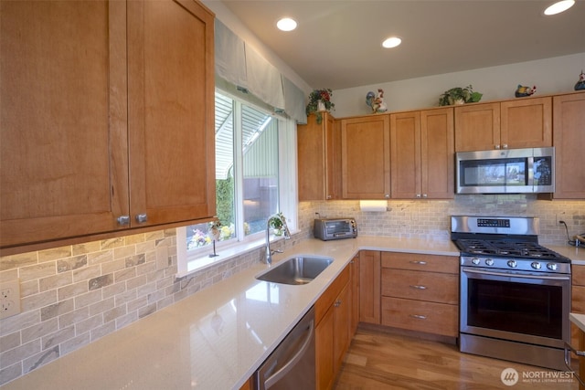 71 Lillian Ridge Dr, Sequim, WA 98382 - kitchen with decorative backsplash, a sink, stainless steel appliances, light wood-type flooring, and recessed lighting