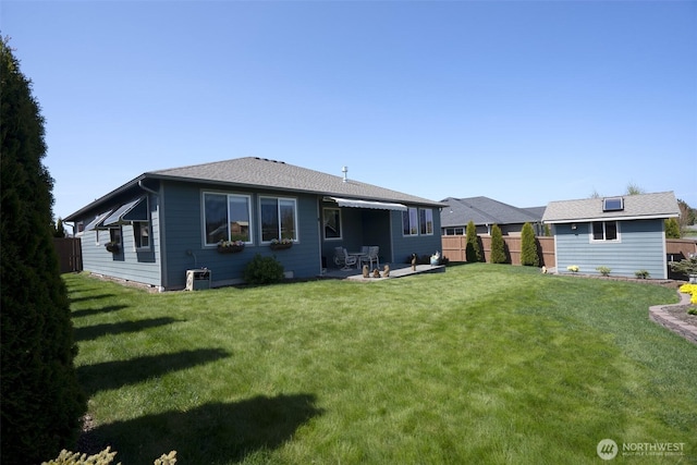 71 Lillian Ridge Dr, Sequim, WA 98382 - rear view of house featuring a patio, a lawn, and fence