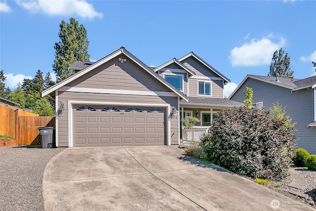 craftsman-style house featuring fence, concrete driveway, and an attached garage