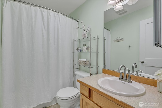 bathroom with toilet and vanity