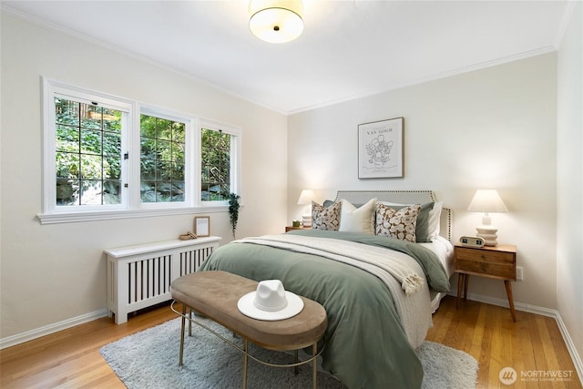 bedroom featuring crown molding, radiator, and multiple windows