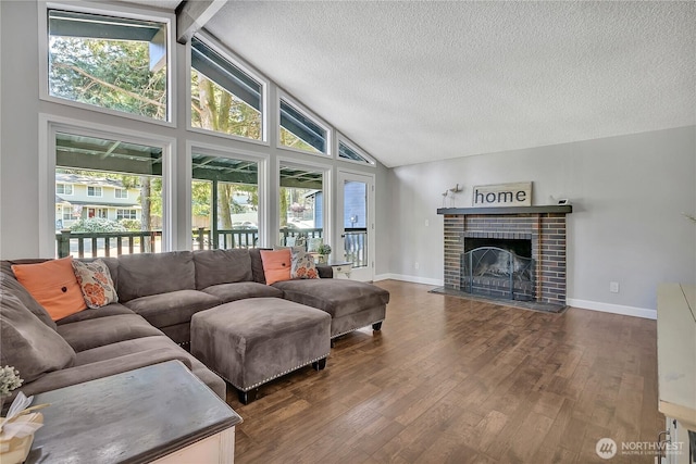 791 NE Pinecrest Dr, Bremerton, WA 98311 - living room featuring healthy amount of natural light, dark wood finished floors, a fireplace, a textured ceiling, and beamed ceiling