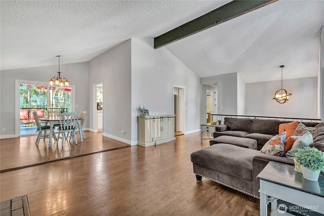 791 NE Pinecrest Dr, Bremerton, WA 98311 - living area featuring a chandelier, beamed ceiling, wood finished floors, a textured ceiling, and baseboards