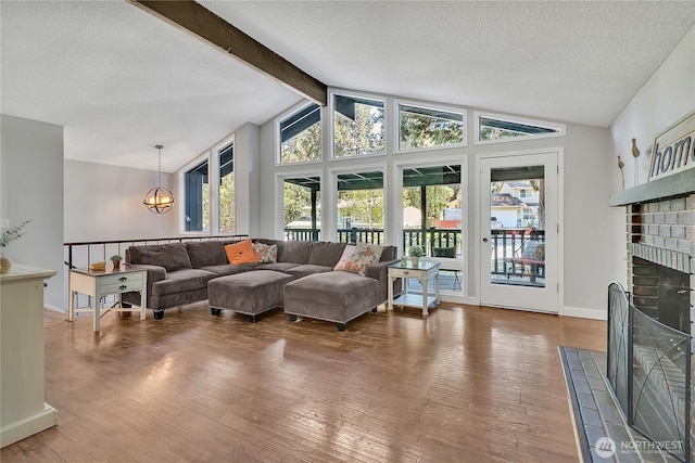 791 NE Pinecrest Dr, Bremerton, WA 98311 - living area featuring hardwood / wood-style floors, a textured ceiling, a fireplace, and baseboards