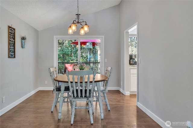 791 NE Pinecrest Dr, Bremerton, WA 98311 - dining room featuring lofted ceiling, a chandelier, wood finished floors, baseboards, and a textured ceiling