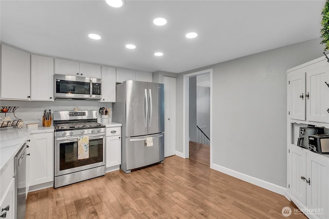 791 NE Pinecrest Dr, Bremerton, WA 98311 - kitchen featuring stainless steel appliances, white cabinetry, light wood finished floors, recessed lighting, and baseboards