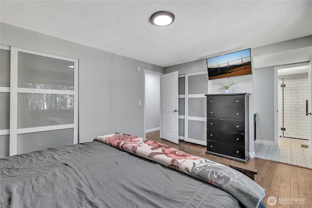 791 NE Pinecrest Dr, Bremerton, WA 98311 - bedroom with wood finished floors, a textured ceiling, and baseboards