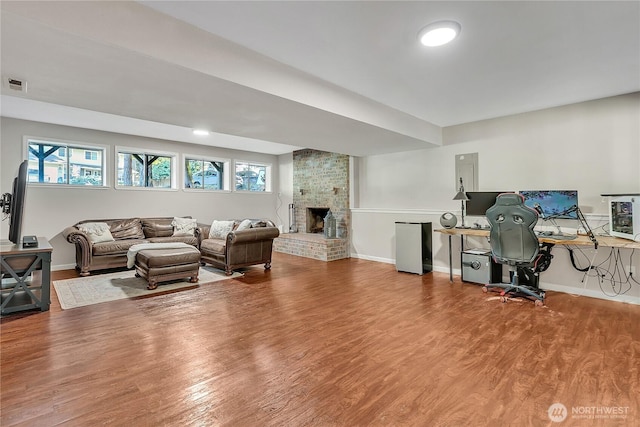 791 NE Pinecrest Dr, Bremerton, WA 98311 - living room with wood finished floors, baseboards, a brick fireplace, and a desk