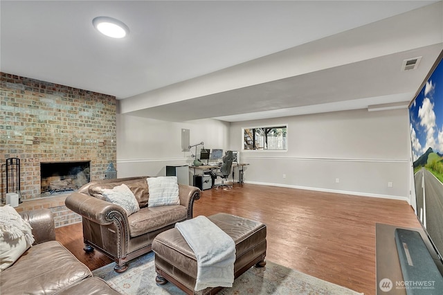 791 NE Pinecrest Dr, Bremerton, WA 98311 - living area featuring baseboards, wood finished floors, and a fireplace