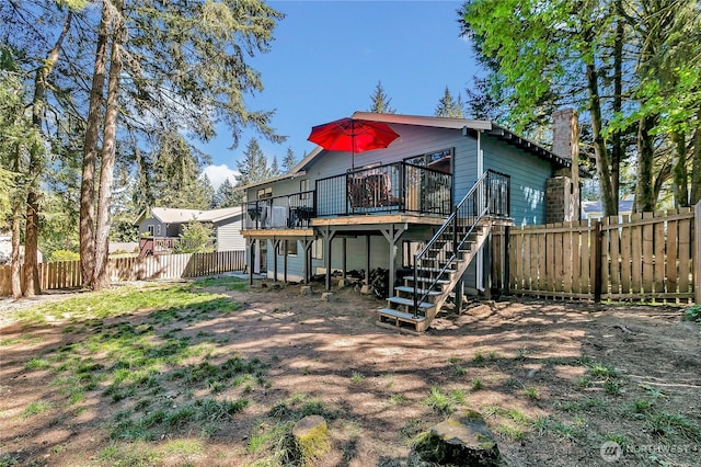 791 NE Pinecrest Dr, Bremerton, WA 98311 - back of house with a wooden deck, stairs, a fenced backyard, and a chimney