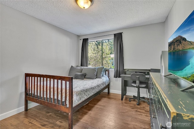 791 NE Pinecrest Dr, Bremerton, WA 98311 - bedroom with wood finished floors, a textured ceiling, baseboards, and a desk