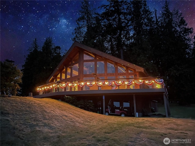 34A Saratoga Dr, Hat Island, WA 98206 - back of house at twilight featuring a carport