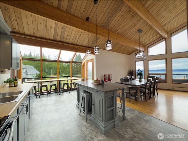 34A Saratoga Dr, Hat Island, WA 98206 - dining area featuring plenty of natural light, a chandelier, vaulted ceiling with beams, and wooden ceiling