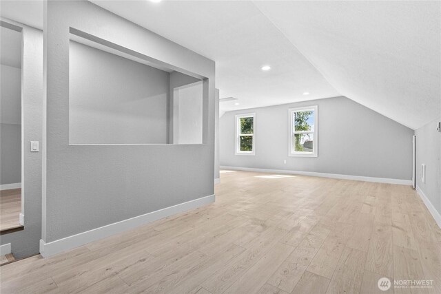 bonus room featuring baseboards, recessed lighting, lofted ceiling, and wood finished floors