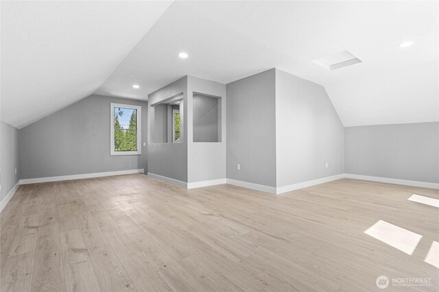 bonus room with recessed lighting, baseboards, vaulted ceiling, and light wood finished floors