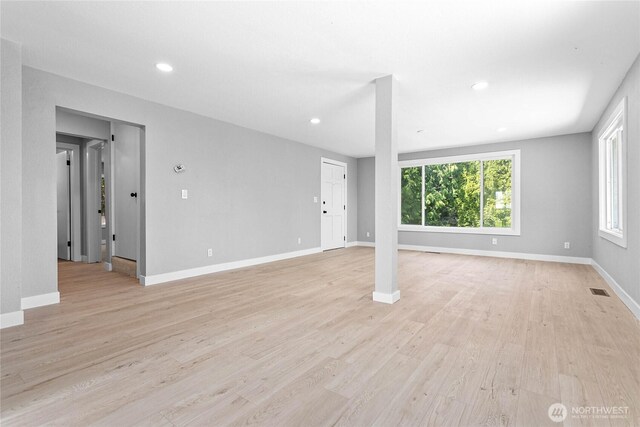 unfurnished living room featuring recessed lighting, baseboards, light wood finished floors, and visible vents