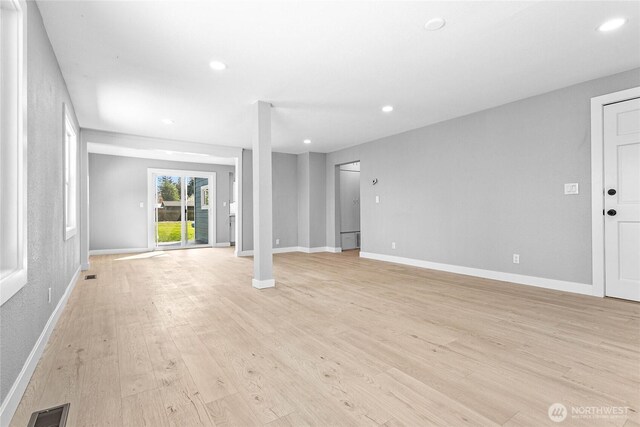 unfurnished living room with recessed lighting, visible vents, and light wood-type flooring