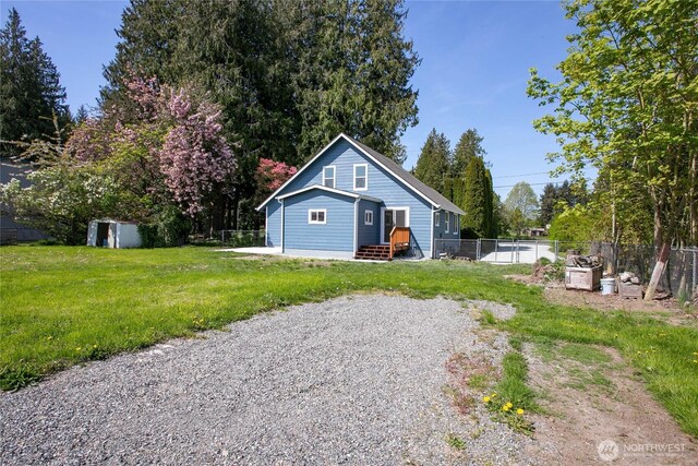 exterior space featuring fence and a storage unit