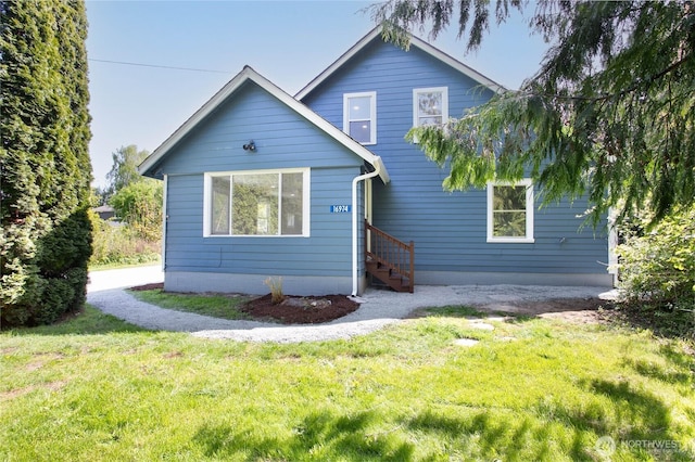 rear view of property featuring a yard