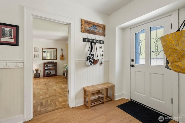interior space with crown molding, parquet floors, and baseboards