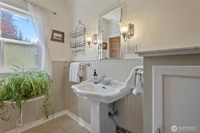bathroom featuring a sink, wainscoting, and tile patterned floors