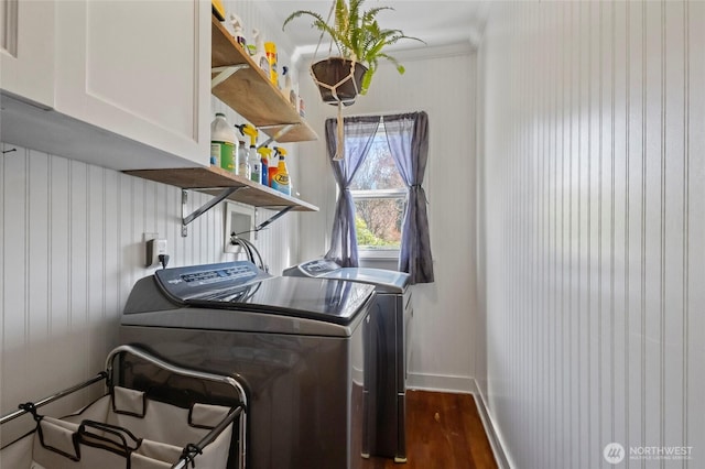 laundry area featuring baseboards, washer and clothes dryer, cabinet space, and dark wood-style flooring