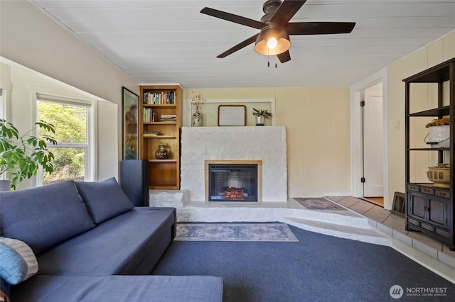 living area with a ceiling fan and a premium fireplace