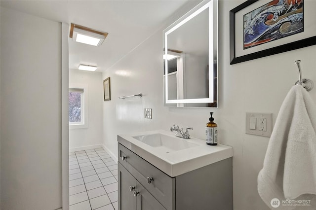 bathroom featuring vanity, tile patterned flooring, and baseboards