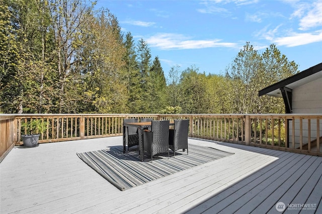 wooden terrace with outdoor dining area