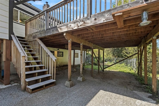 view of patio / terrace featuring stairs and a carport