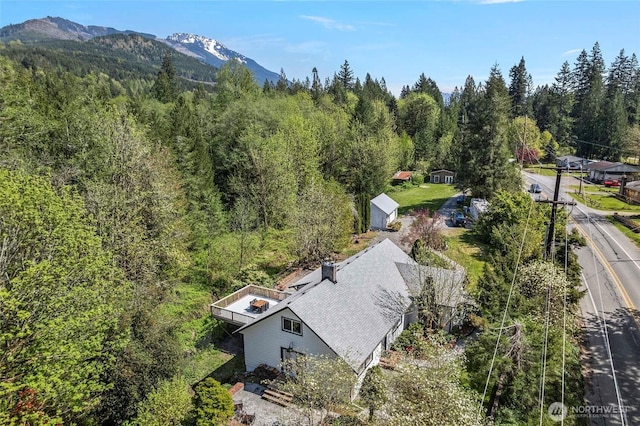 aerial view featuring a view of trees and a mountain view