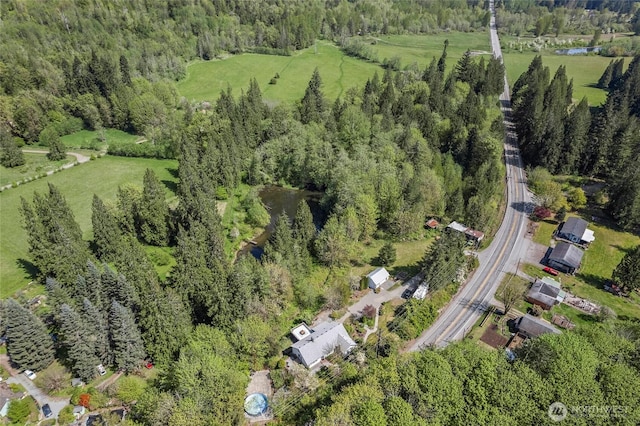 drone / aerial view featuring a forest view