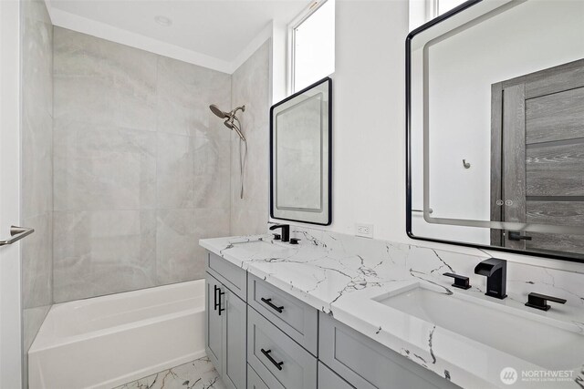 bathroom with a sink, bathtub / shower combination, double vanity, and marble finish floor