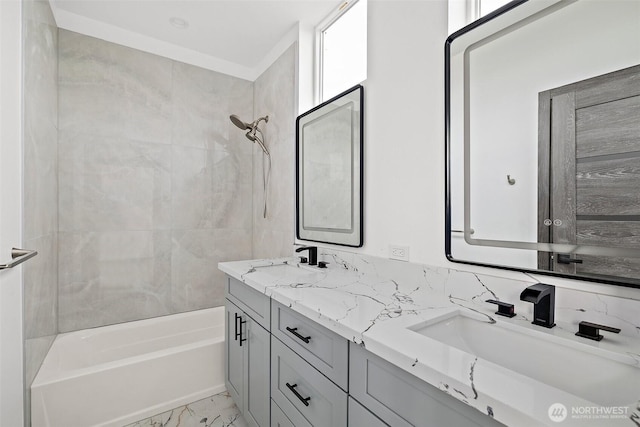 bathroom with a sink, bathtub / shower combination, double vanity, and marble finish floor