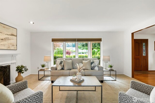 living area with recessed lighting, baseboards, and a fireplace