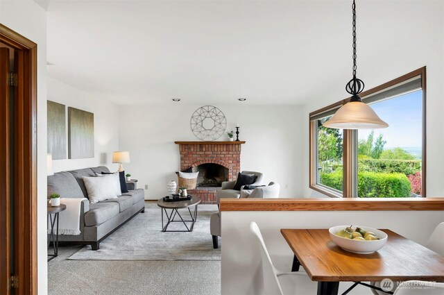 living area with a fireplace and light colored carpet