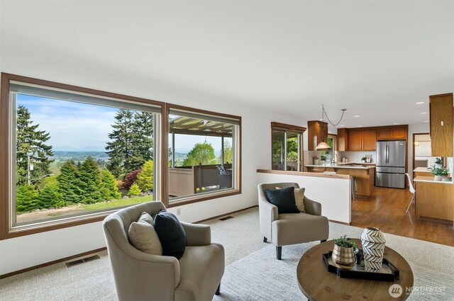 living room featuring baseboards, recessed lighting, wood finished floors, and visible vents