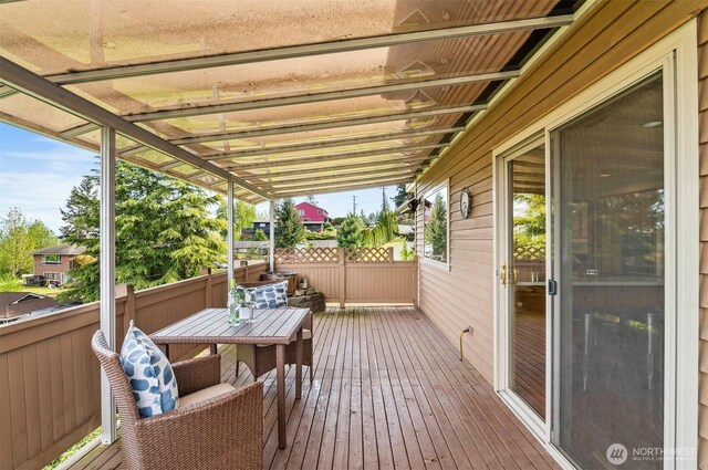 wooden terrace with outdoor dining area