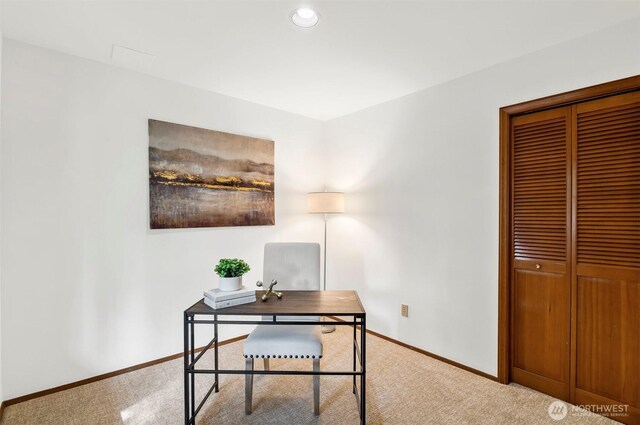 carpeted home office featuring baseboards