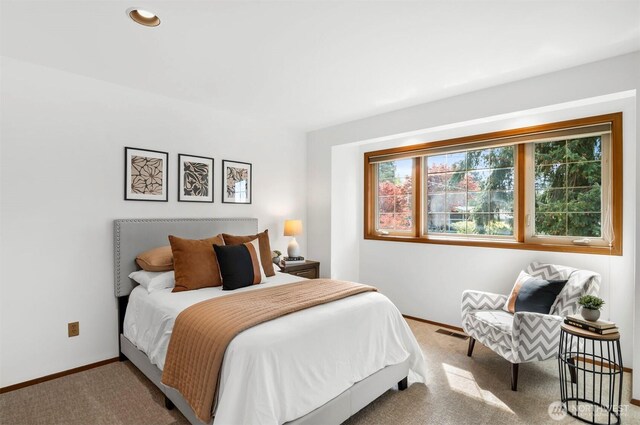 bedroom featuring baseboards, carpet flooring, and visible vents