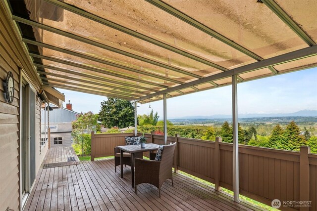 wooden terrace featuring outdoor dining area