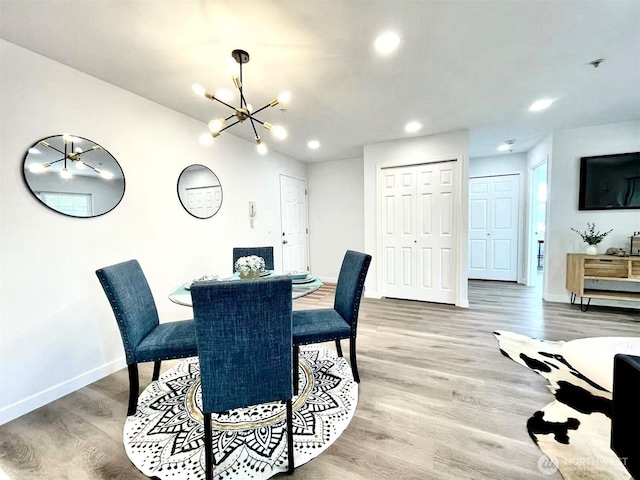 dining area with a chandelier, baseboards, light wood-style floors, and recessed lighting