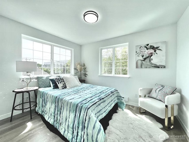 bedroom featuring baseboards and wood finished floors
