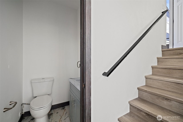 stairs featuring baseboards and marble finish floor
