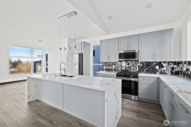 kitchen with gray cabinets, appliances with stainless steel finishes, decorative backsplash, and a sink