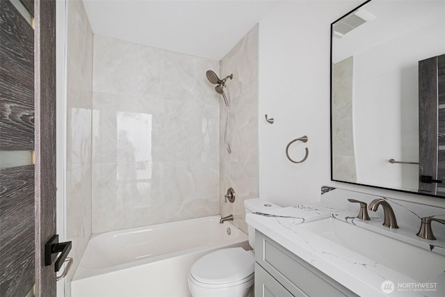 full bathroom featuring shower / bathtub combination, toilet, and vanity