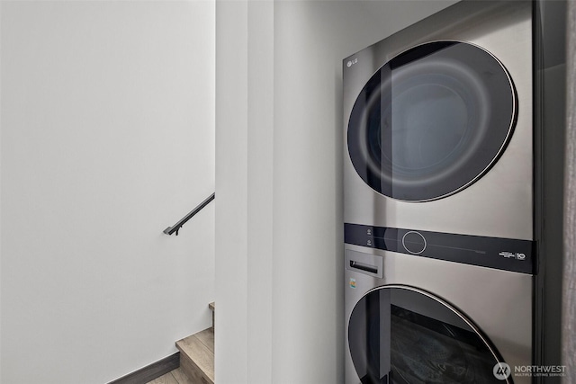 laundry room featuring stacked washing maching and dryer and laundry area