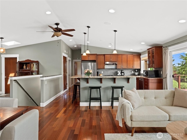 17111 NE 5th St, Bellevue, WA 98008 - kitchen featuring appliances with stainless steel finishes, open floor plan, lofted ceiling, under cabinet range hood, and dark wood finished floors