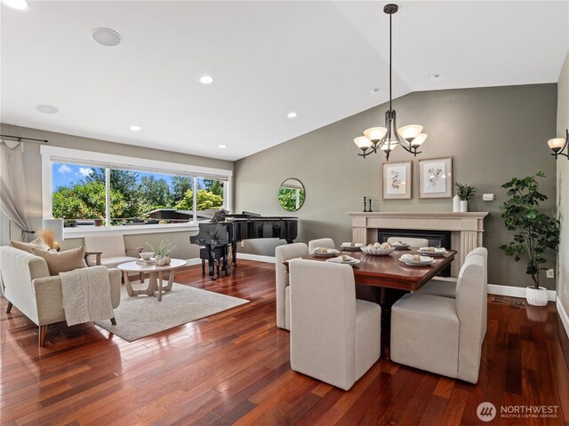 17111 NE 5th St, Bellevue, WA 98008 - dining space with wood-type flooring, lofted ceiling, baseboards, a chandelier, and a glass covered fireplace