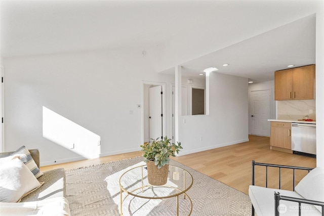 living room with baseboards, recessed lighting, and light wood finished floors